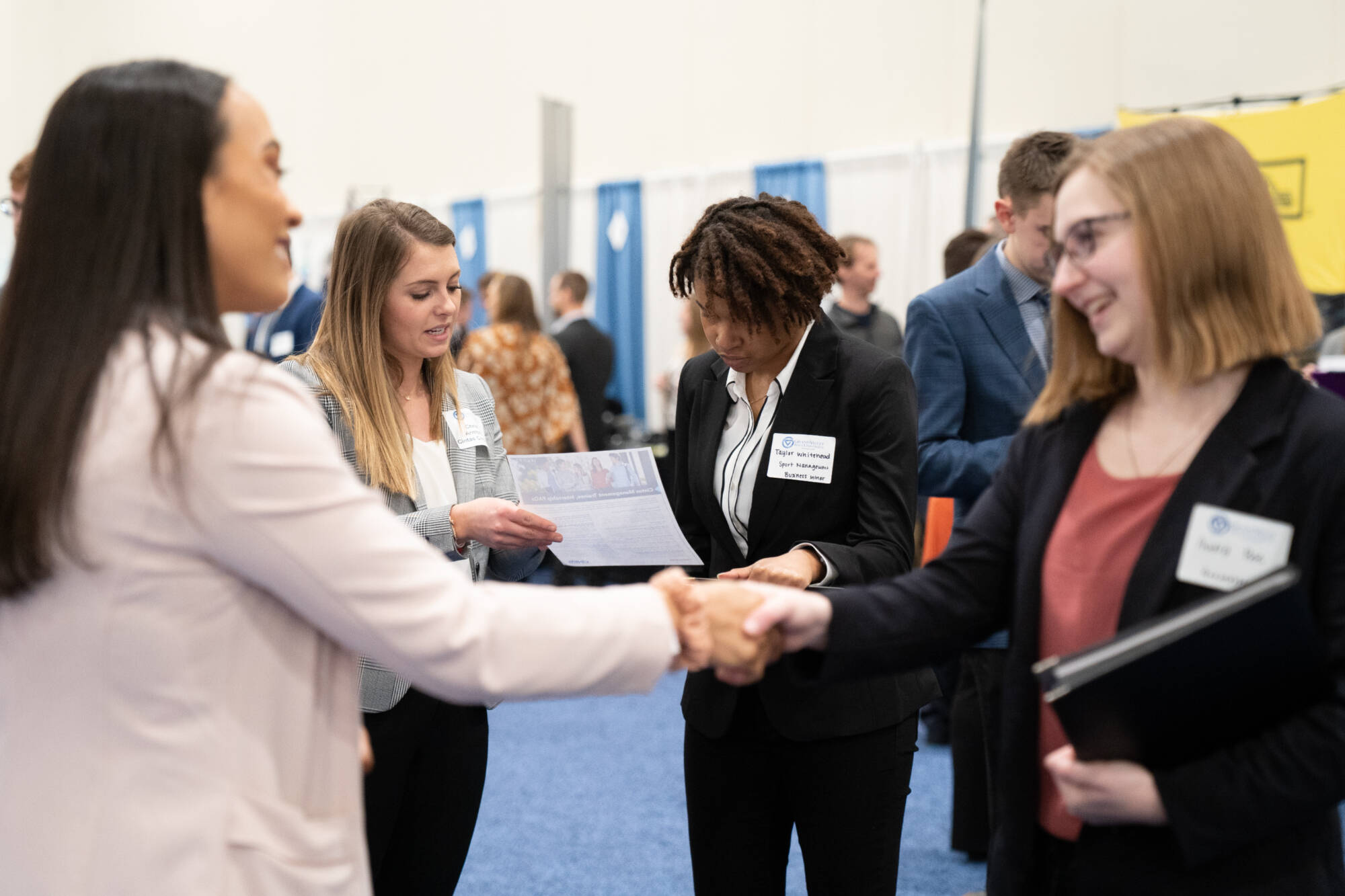 networking event with participants shaking hands